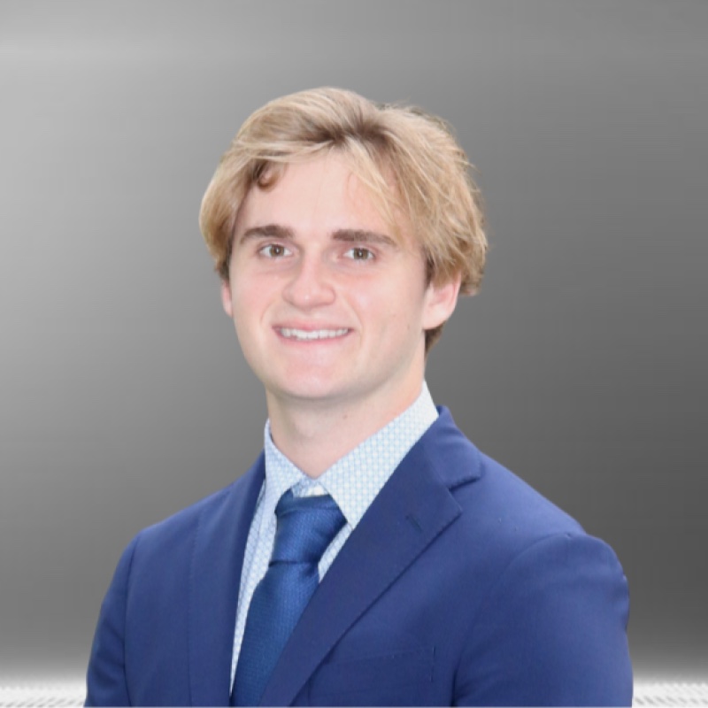 Professional headshot of Christian Ringpfiel in a navy suit and blue tie