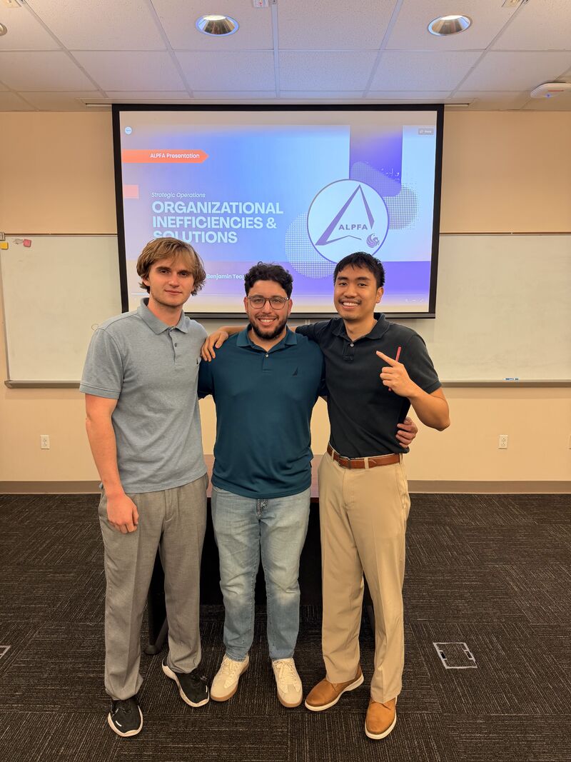 Christian and a teammate in front of their Organizational Inefficiencies presentation
